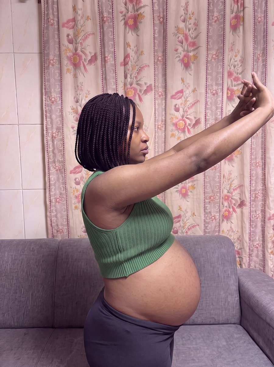 Full body photo showing a visibly swollen fibroid belly